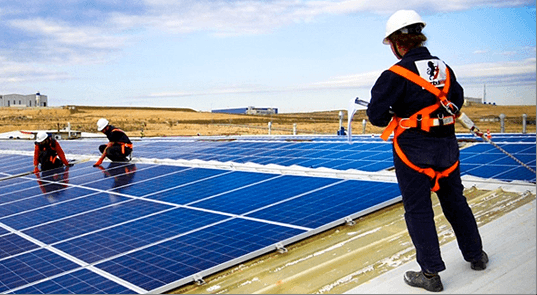 solar installers on flat roof